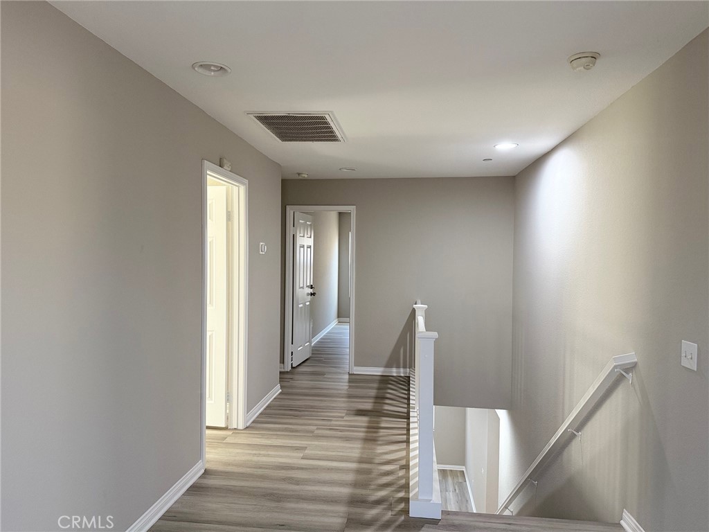 4547 Nicole Way Riverside, CA 92501 - Photo 28 of 36 a view of a hallway with wooden floor and staircase