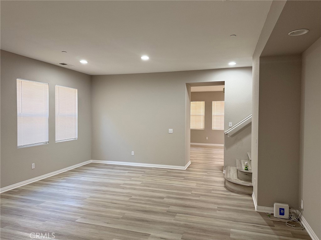 4547 Nicole Way Riverside, CA 92501 - Photo 3 of 36 an empty room with wooden floor and windows