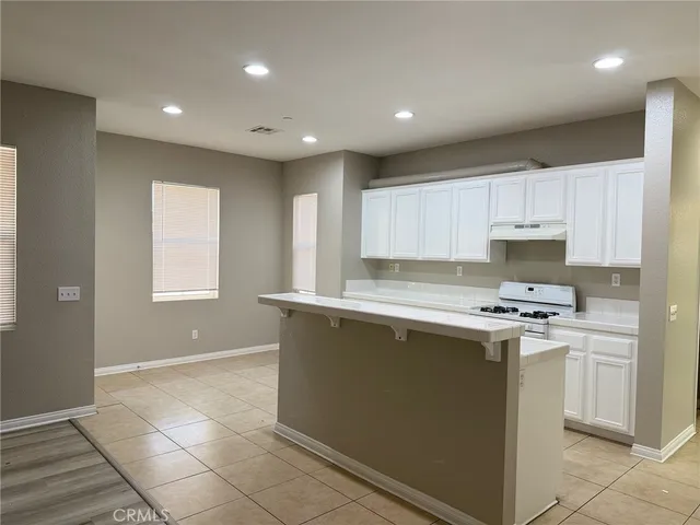 a kitchen with a stove a sink and a refrigerator