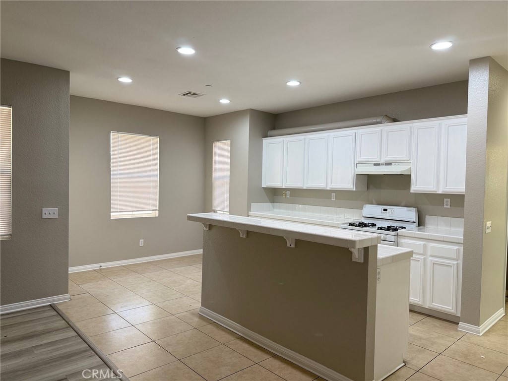 4547 Nicole Way Riverside, CA 92501 - Photo 5 of 36 a kitchen with a stove a sink and a refrigerator