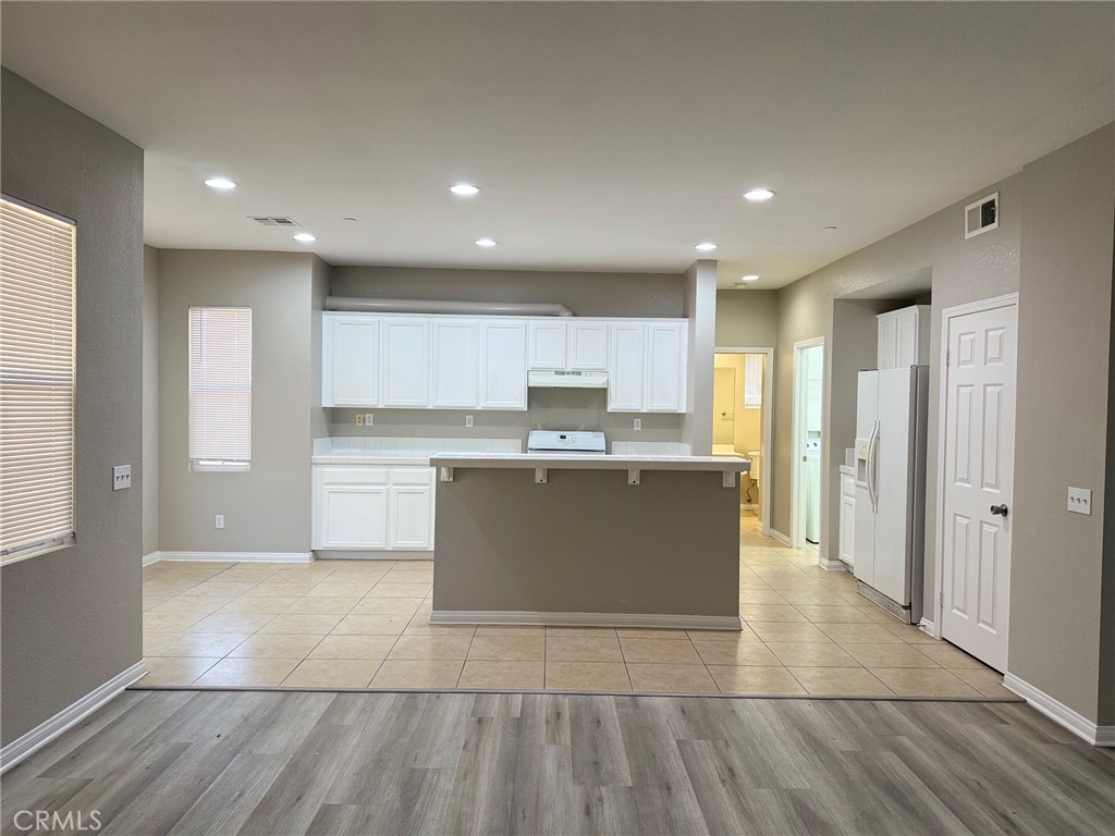 4547 Nicole Way Riverside, CA 92501 - Photo 6 of 36 a large kitchen with stainless steel appliances granite countertop a large counter top and a stove top oven