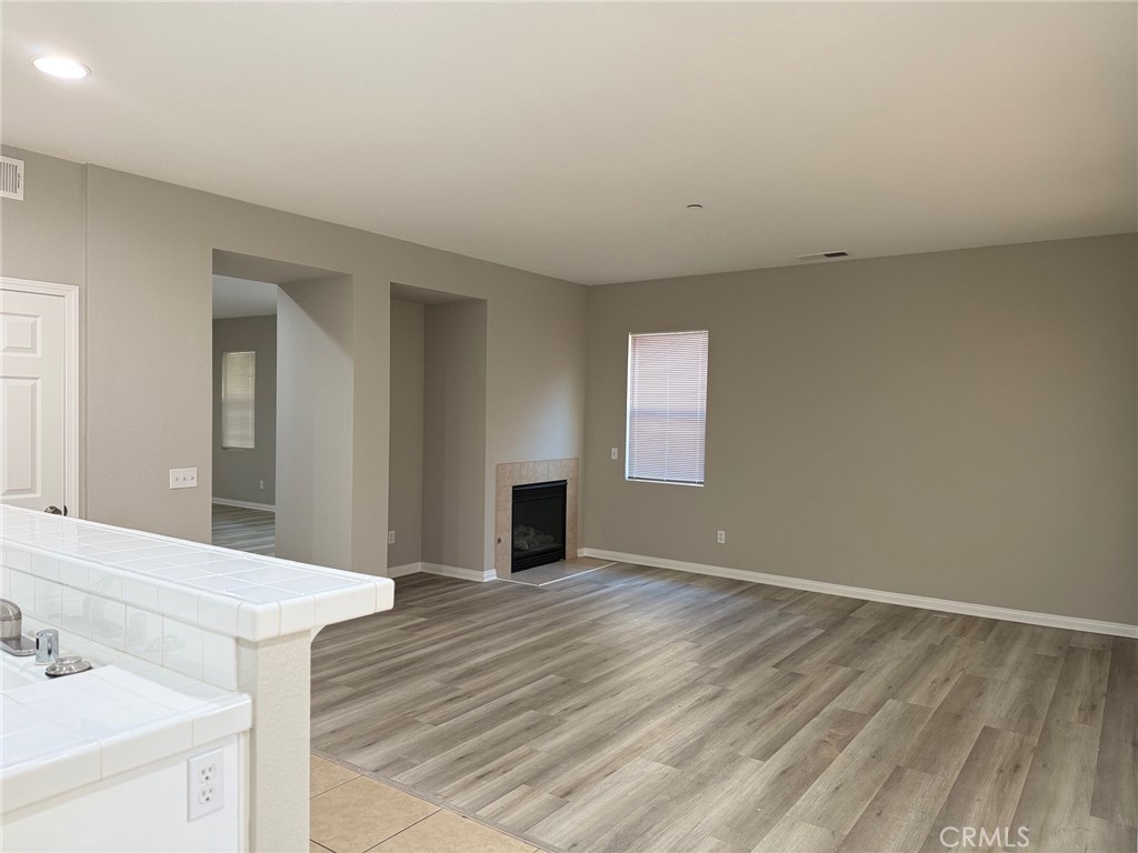 4547 Nicole Way Riverside, CA 92501 - Photo 7 of 36 a view of empty room with wooden floor and fan