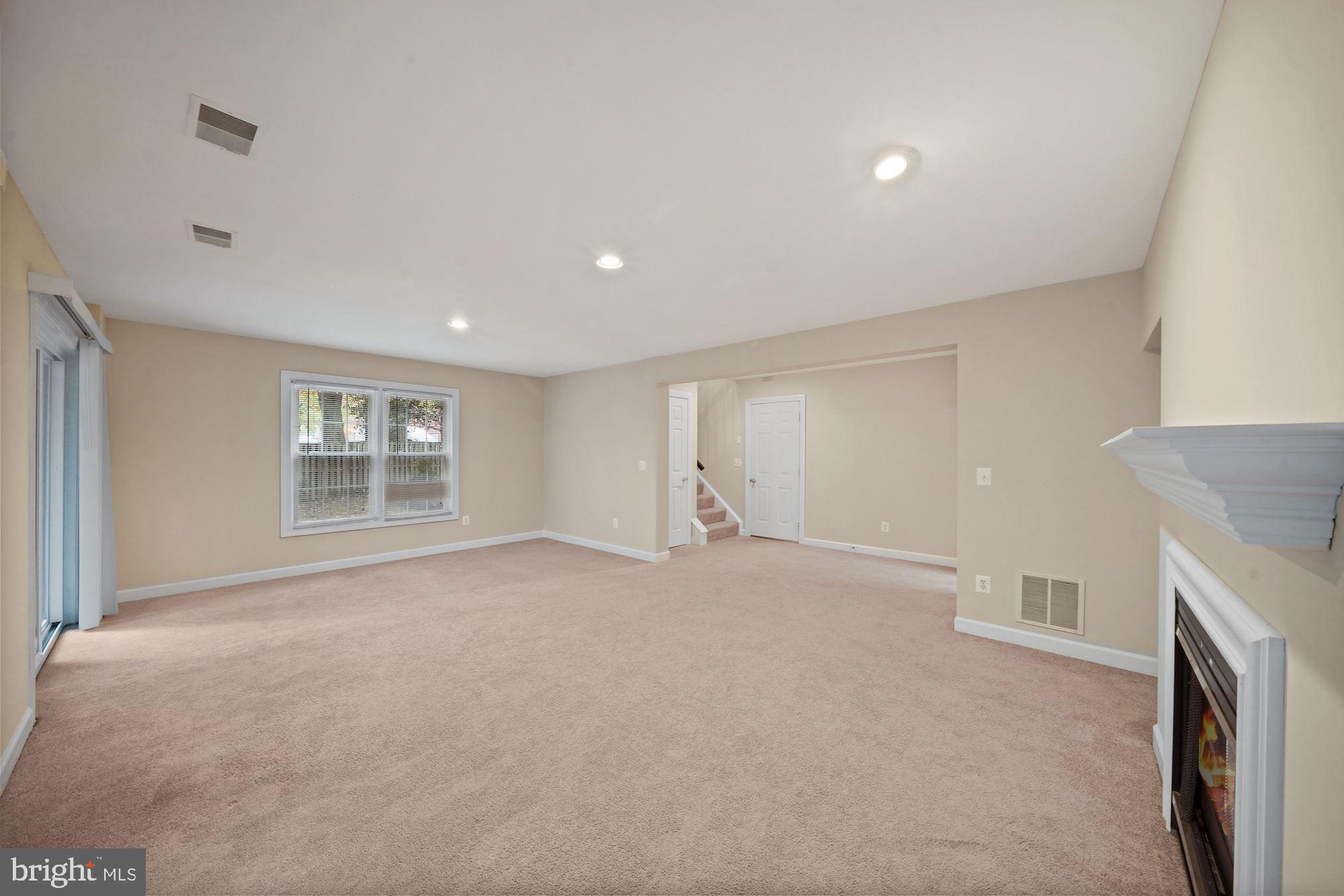 123 Roland Court Southwest Vienna, VA 22180 - Photo 29 of 34 Gas fireplace and recessed lights in rec room