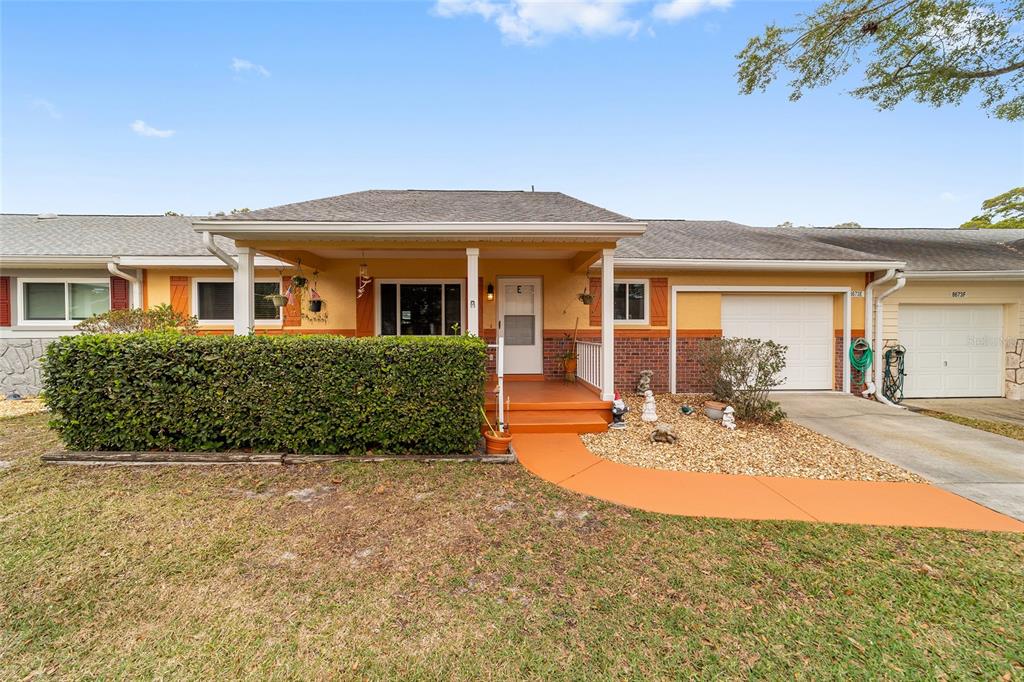 8673 Southwest 96th Lane, Unit E Ocala, FL 34481 - Photo 1 of 1 a view of a house with backyard and sitting area