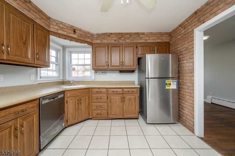 136 Valpeck Avenue, Unit 1 Raritan, NJ 08869 - Photo 11 of 37 a kitchen with a refrigerator a sink and dishwasher
