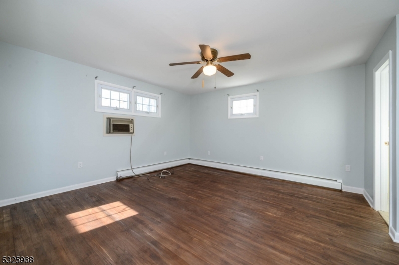 136 Valpeck Avenue, Unit 1 Raritan, NJ 08869 - Photo 16 of 37 wooden floor in an empty room with a window