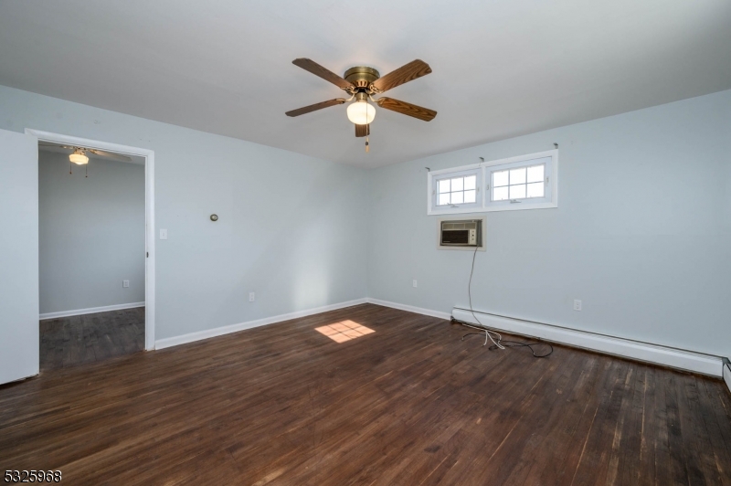 136 Valpeck Avenue, Unit 1 Raritan, NJ 08869 - Photo 19 of 37 an empty room with wooden floor a ceiling fan and closet