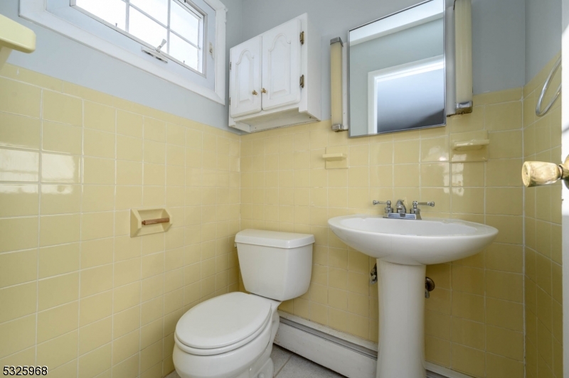 136 Valpeck Avenue, Unit 1 Raritan, NJ 08869 - Photo 20 of 37 a bathroom with a toilet sink and mirror