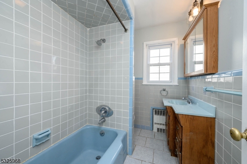136 Valpeck Avenue, Unit 1 Raritan, NJ 08869 - Photo 25 of 37 a bathroom with a sink a toilet and bathtub