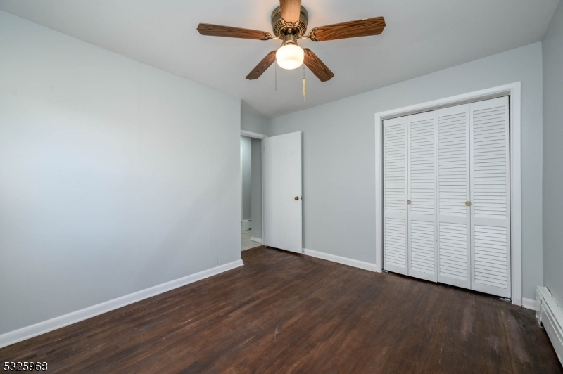 136 Valpeck Avenue, Unit 1 Raritan, NJ 08869 - Photo 28 of 37 an empty room with wooden floor closet fan and windows