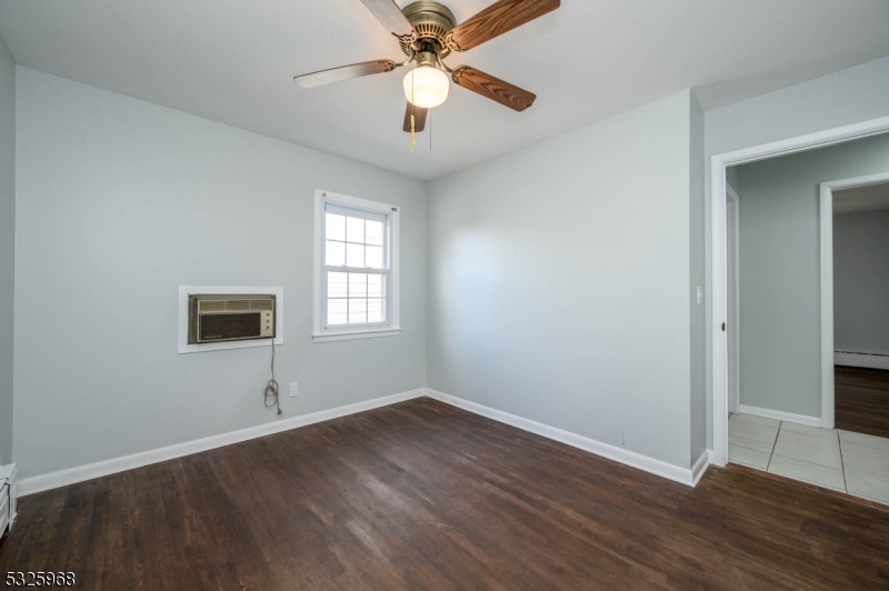 136 Valpeck Avenue, Unit 1 Raritan, NJ 08869 - Photo 29 of 37 an empty room with wooden floor closet and windows