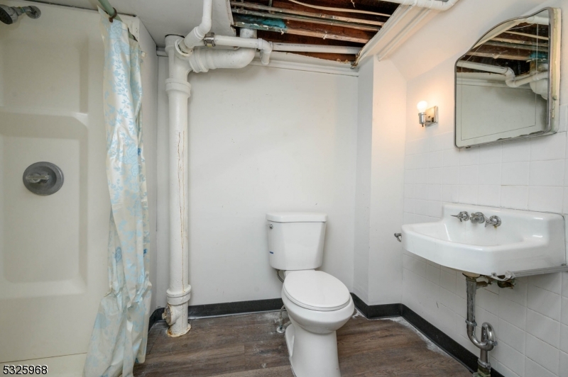 136 Valpeck Avenue, Unit 1 Raritan, NJ 08869 - Photo 30 of 37 a bathroom with a sink toilet and shower
