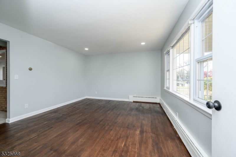 136 Valpeck Avenue, Unit 1 Raritan, NJ 08869 - Photo 4 of 37 wooden floor in an empty room with a window