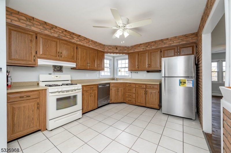 136 Valpeck Avenue, Unit 1 Raritan, NJ 08869 - Photo 9 of 37 a kitchen with a stove sink and refrigerator