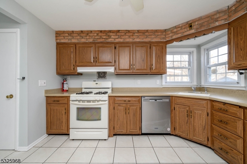 136 Valpeck Avenue, Unit 1 Raritan, NJ 08869 - Photo 10 of 37 a kitchen with cabinets appliances and a window