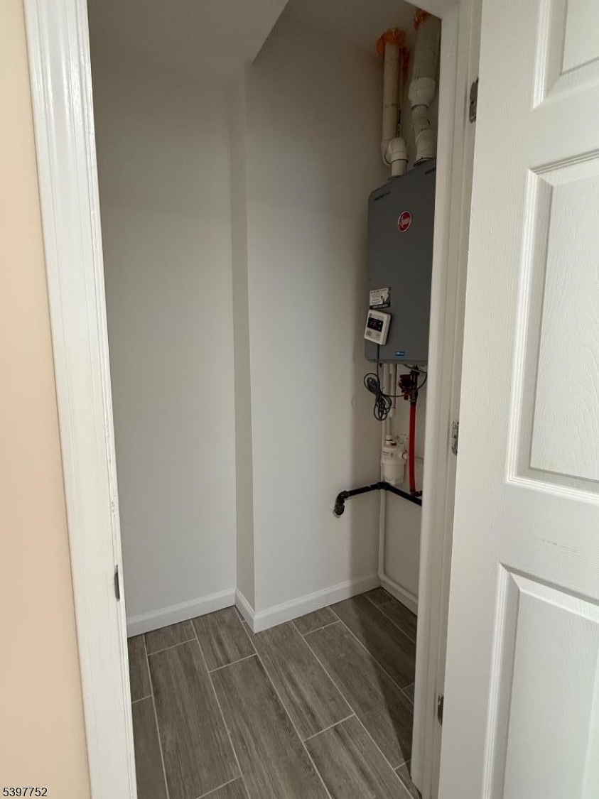208 Walnut Street Newark, NJ 07105 - Photo 12 of 18 a view of a hallway with wooden floor and closet