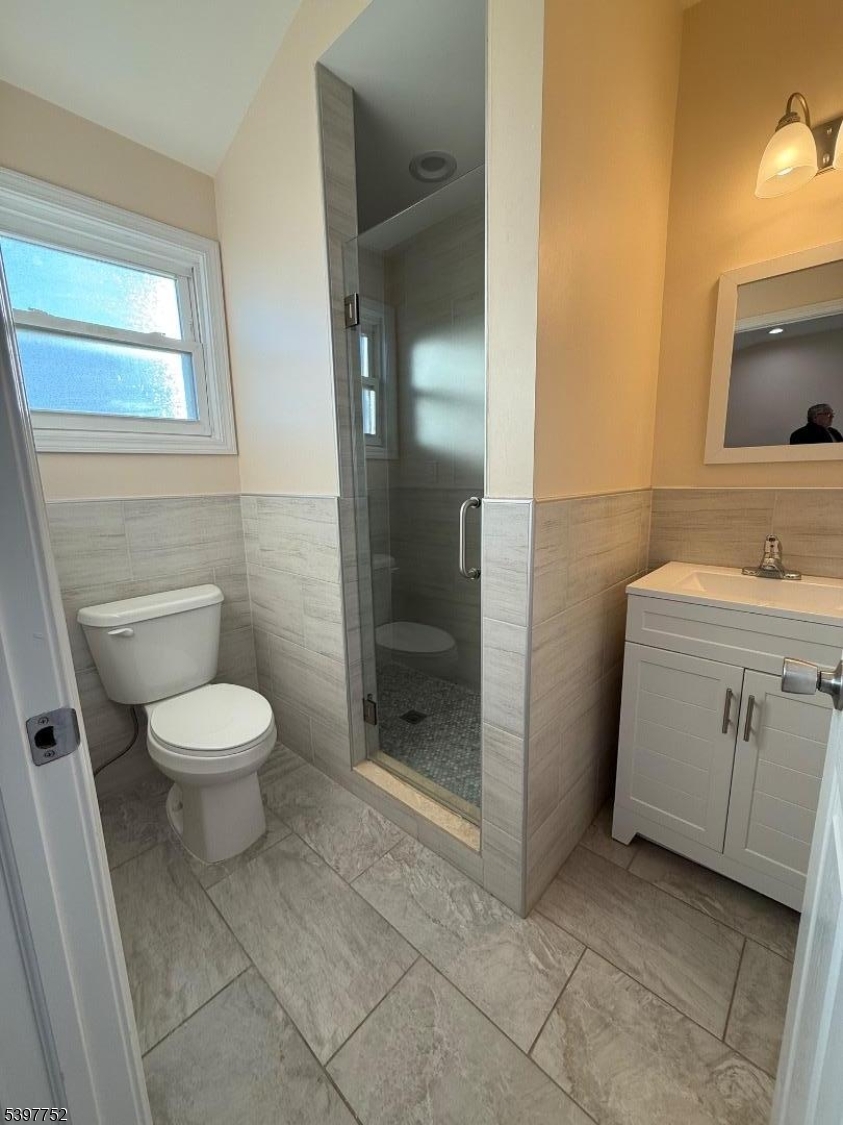 208 Walnut Street Newark, NJ 07105 - Photo 17 of 18 a bathroom with a toilet a sink and shower