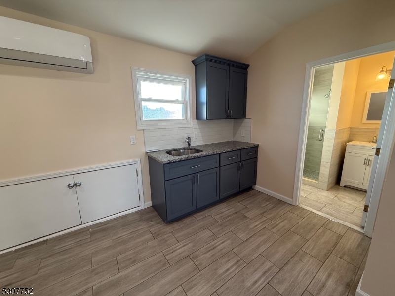 208 Walnut Street Newark, NJ 07105 - Photo 18 of 18 a view of a kitchen with wooden floor and electronic appliances