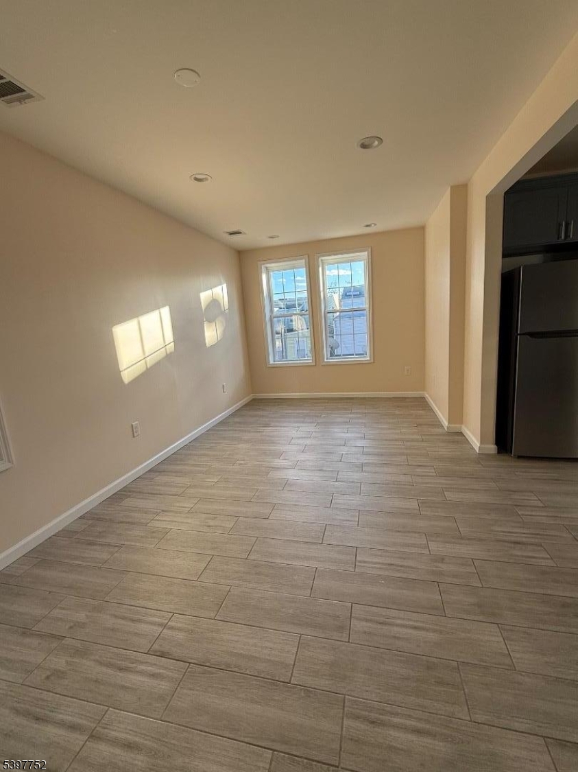 208 Walnut Street Newark, NJ 07105 - Photo 3 of 18 a view of empty room with window and fireplace