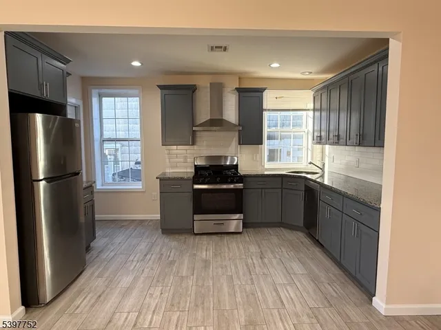 a kitchen with a refrigerator and a sink