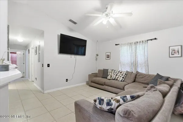 a living room with furniture and a flat screen tv