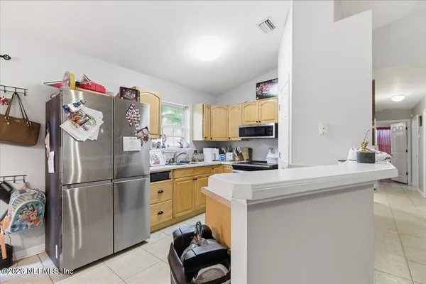 a kitchen with stainless steel appliances a refrigerator sink and cabinets
