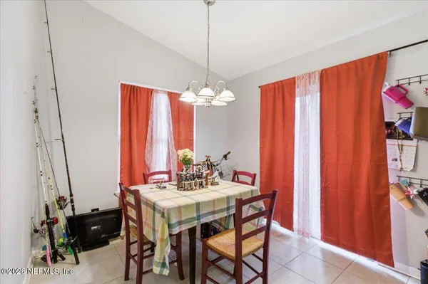 a dining room with furniture and window