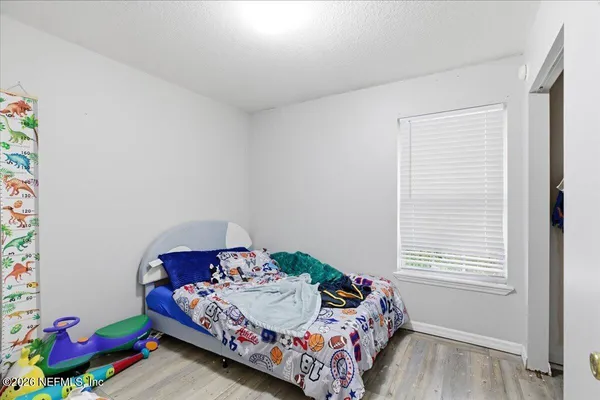 a bedroom with bed and a window