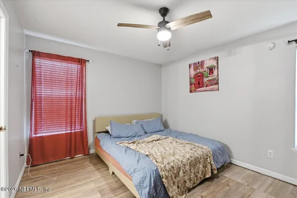 a bedroom with a bed and a window