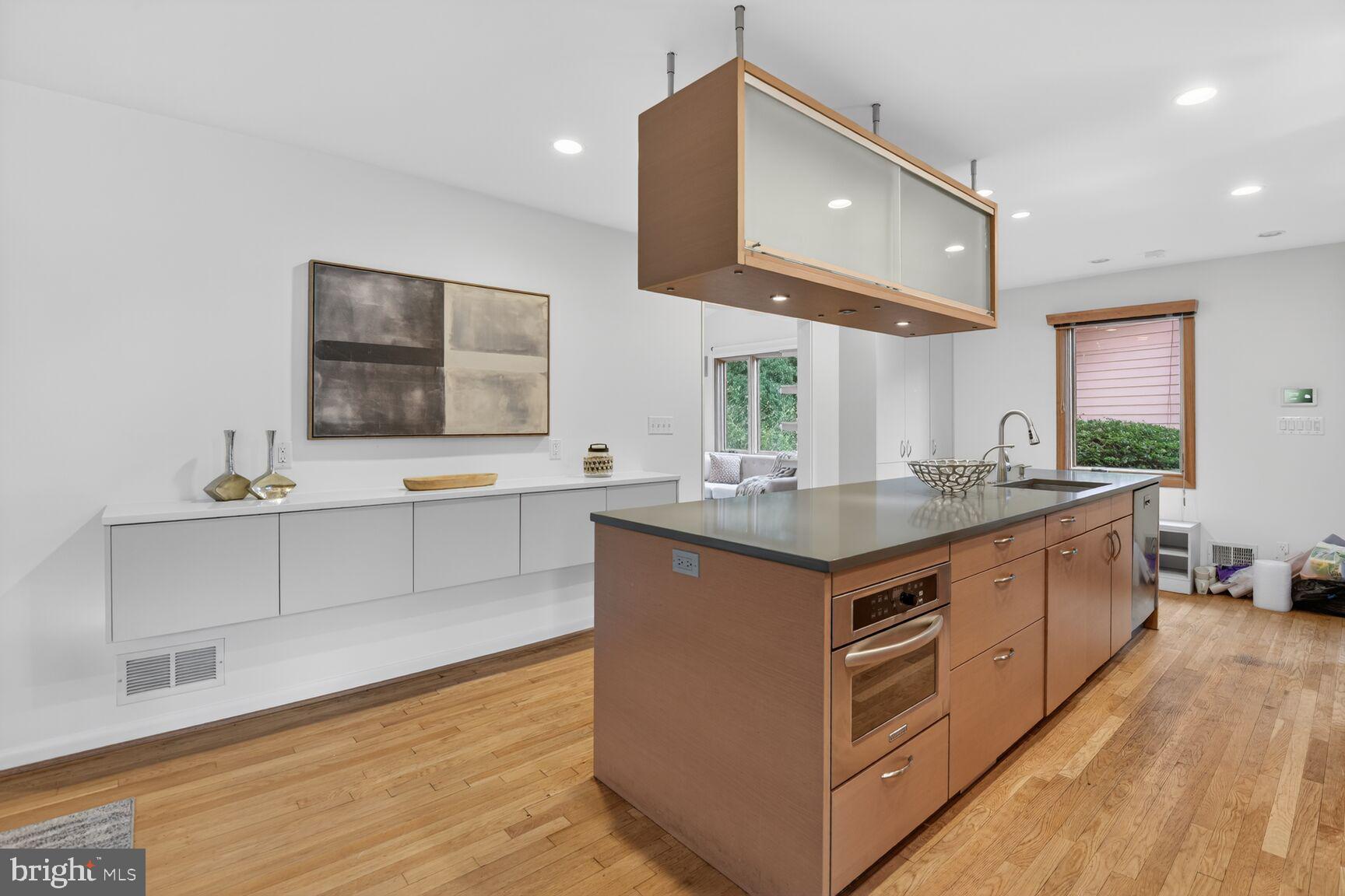 6104 Robinwood Road Bethesda, MD 20817 - Photo 11 of 45 a kitchen with stainless steel appliances granite countertop a sink and a wooden floors