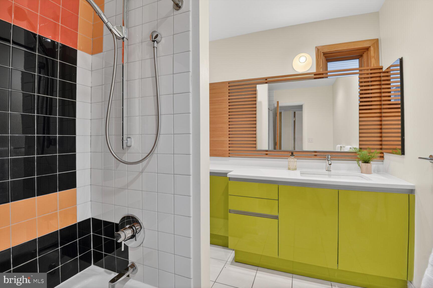 6104 Robinwood Road Bethesda, MD 20817 - Photo 19 of 45 a bathroom with a sink a mirror and a shower