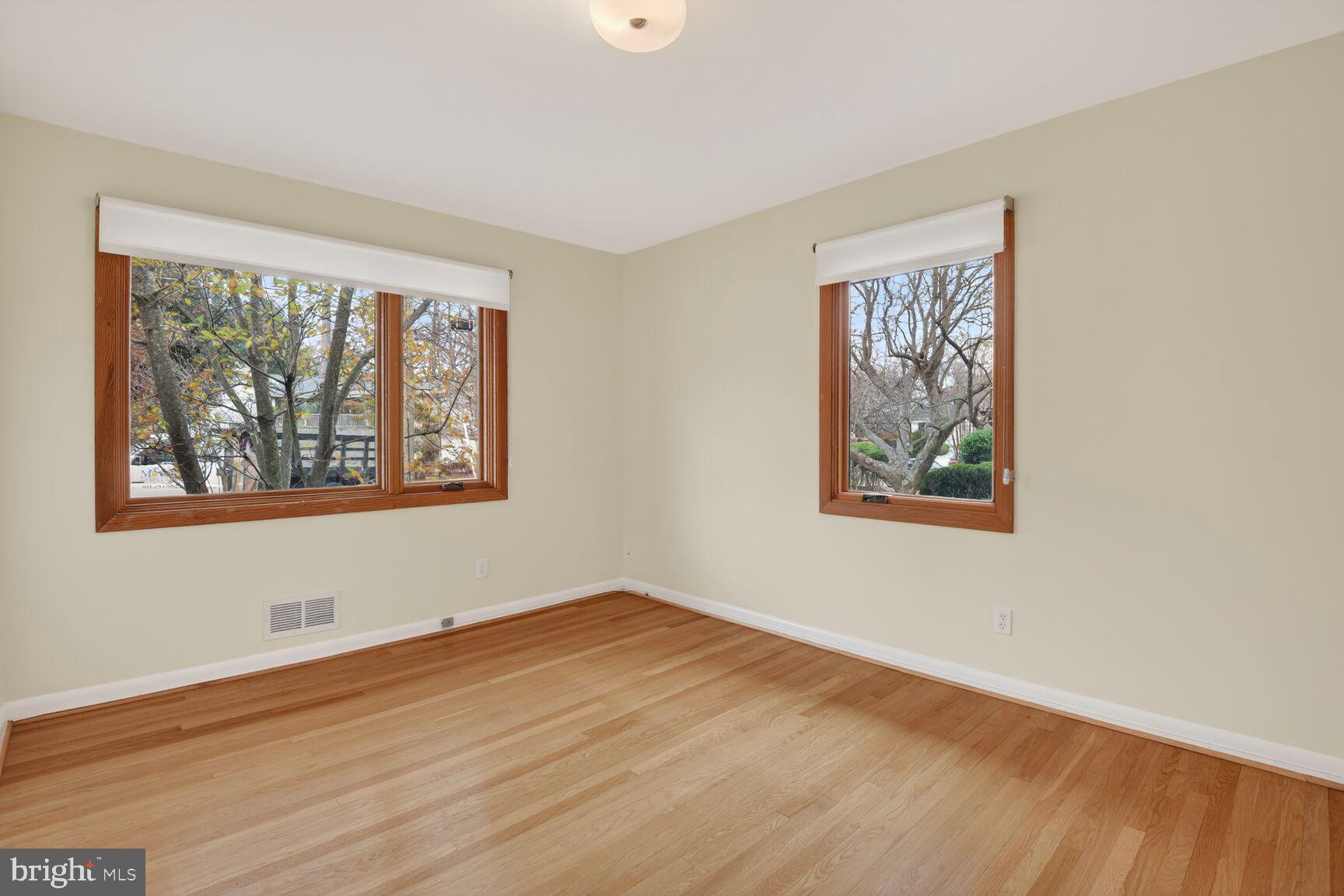 6104 Robinwood Road Bethesda, MD 20817 - Photo 21 of 45 a view of an empty room with wooden floor and a window