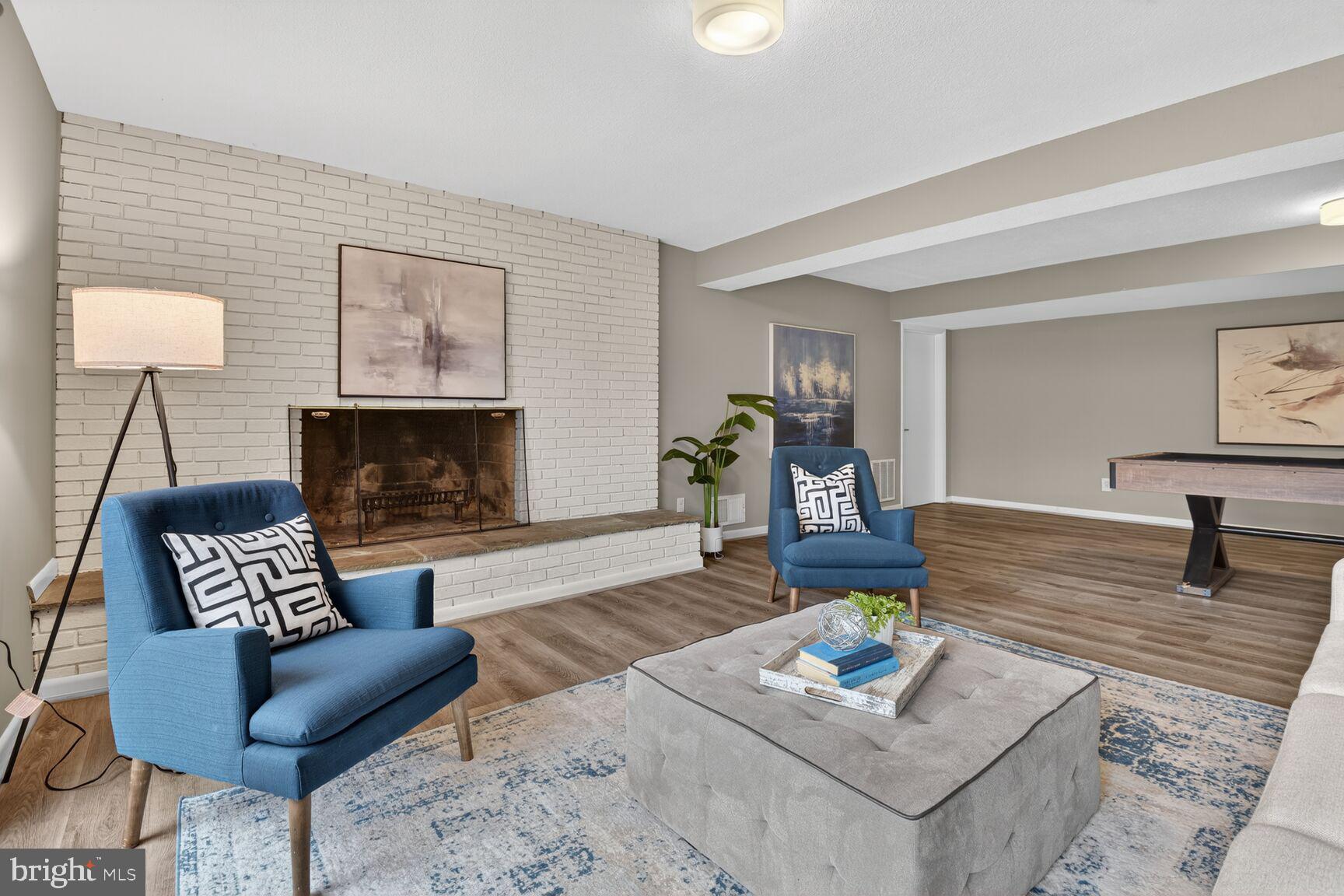 6104 Robinwood Road Bethesda, MD 20817 - Photo 30 of 45 a living room with furniture and a fireplace