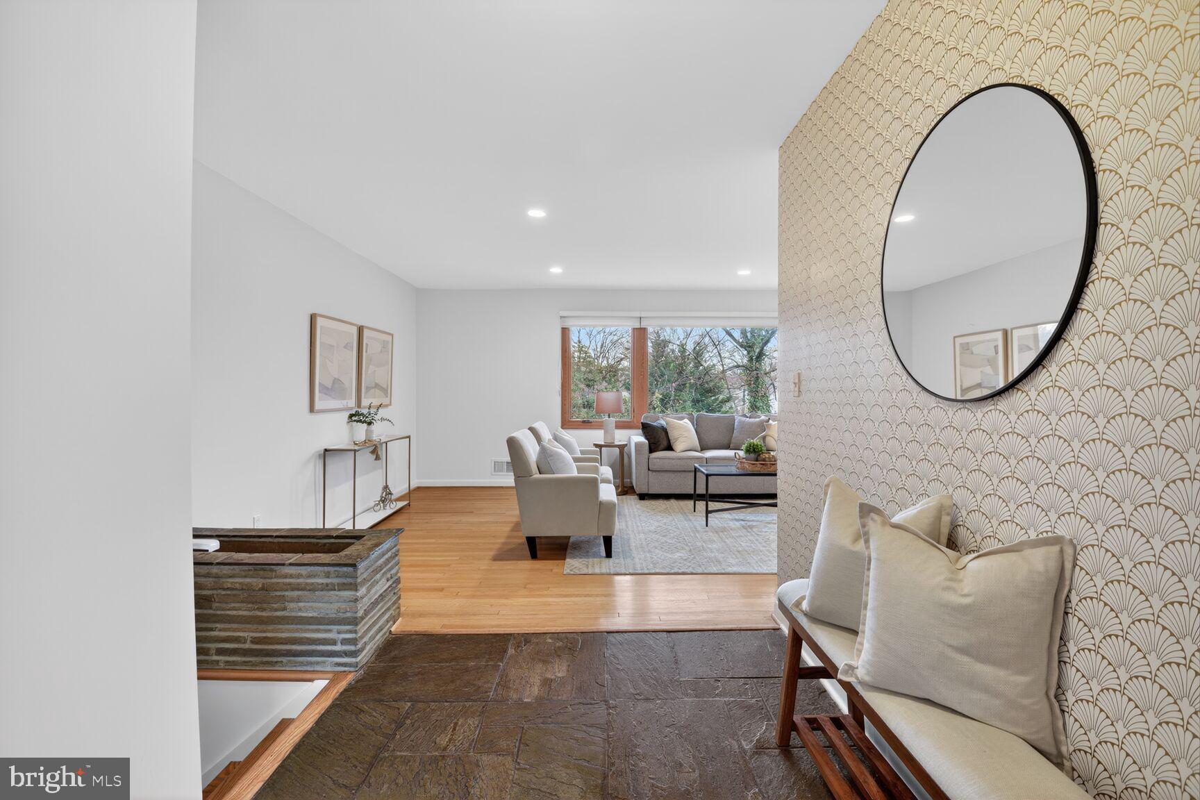 6104 Robinwood Road Bethesda, MD 20817 - Photo 3 of 45 a living room with furniture a rug and a mirror