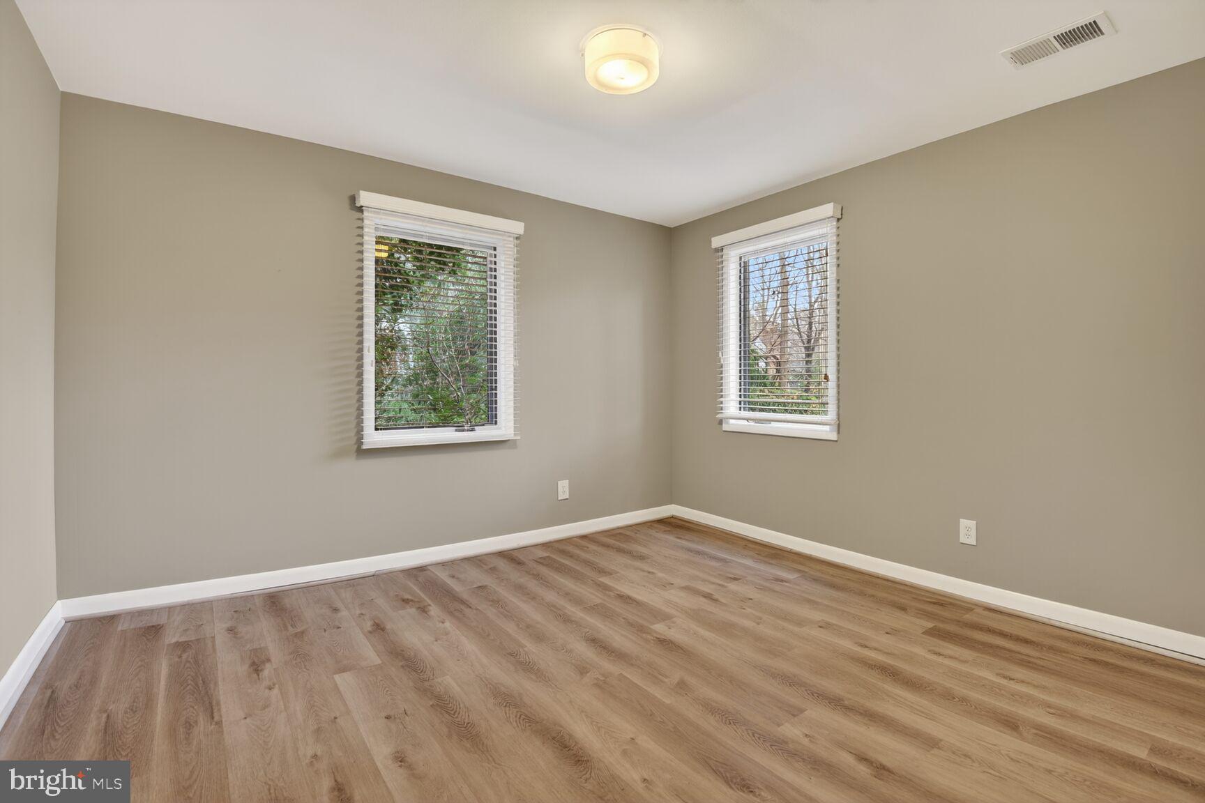 6104 Robinwood Road Bethesda, MD 20817 - Photo 32 of 45 a view of an empty room with wooden floor and a window
