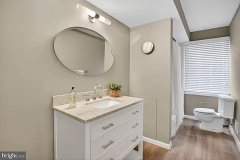 a bathroom with a toilet a sink and a mirror