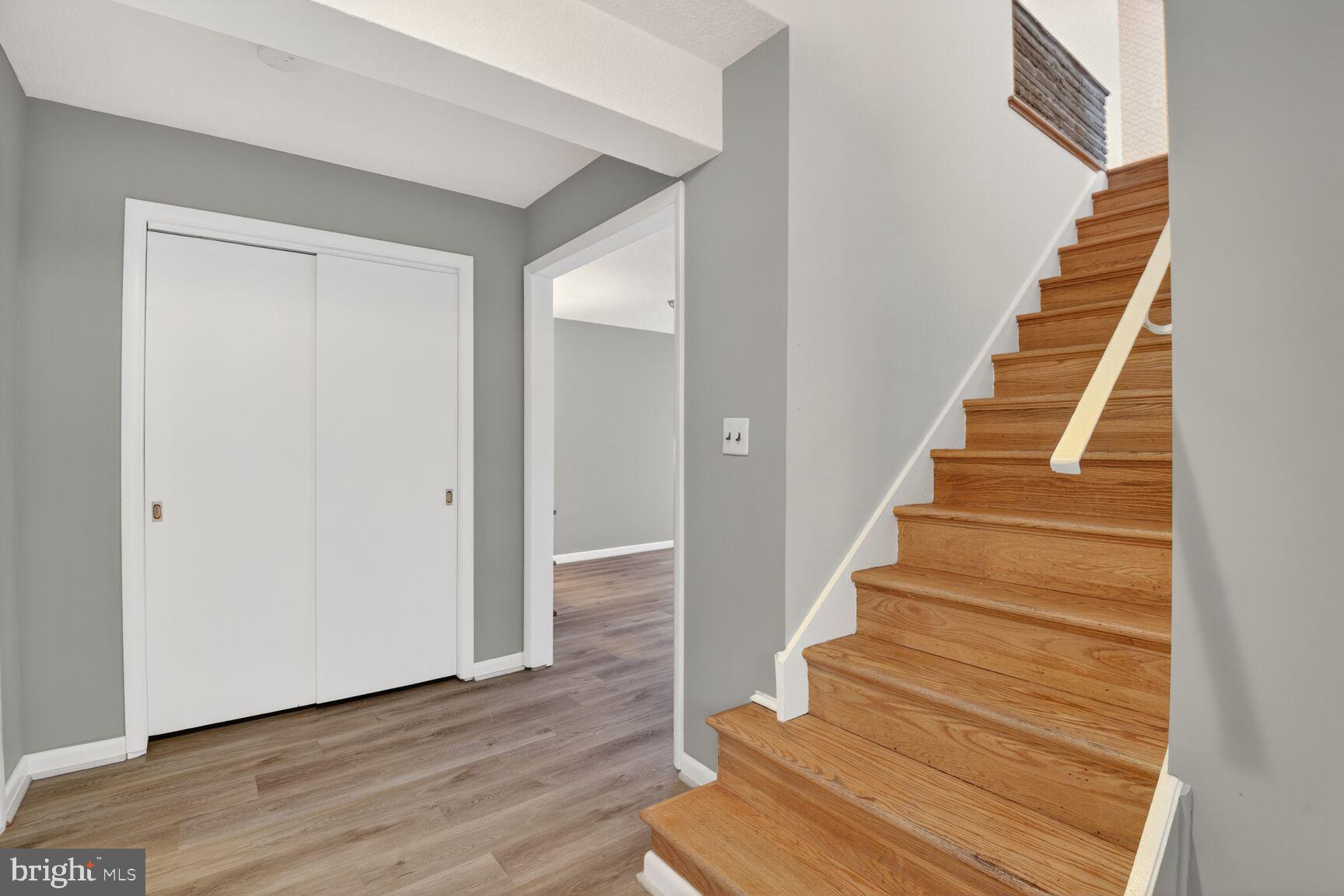 6104 Robinwood Road Bethesda, MD 20817 - Photo 35 of 45 a view of staircase with wooden floor and lots of frames on wall