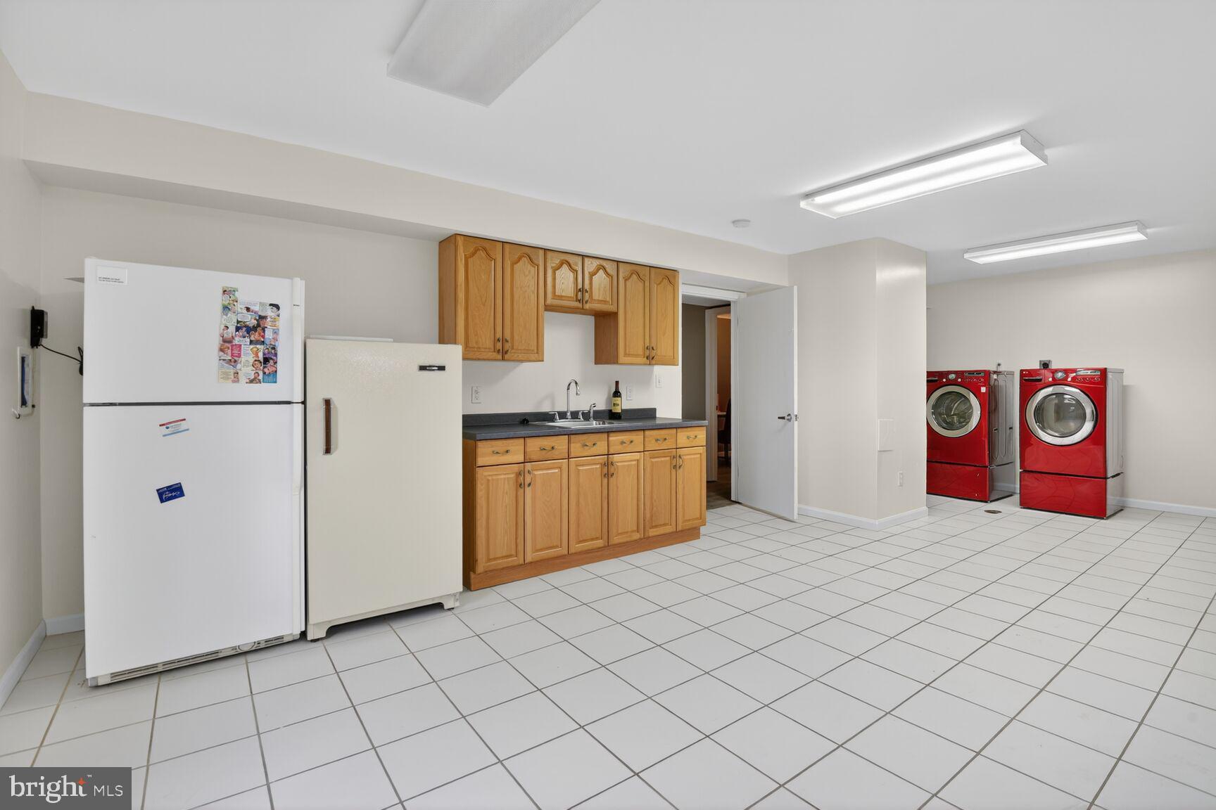 6104 Robinwood Road Bethesda, MD 20817 - Photo 37 of 45 a kitchen with cabinets and white appliances