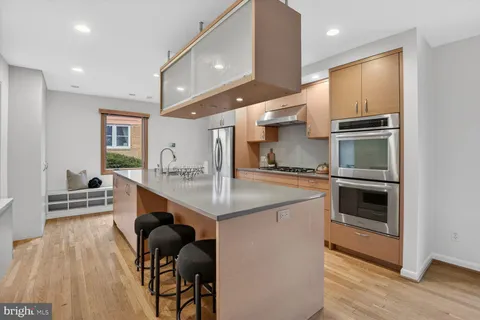 a kitchen with kitchen island a large counter top space appliances and cabinets