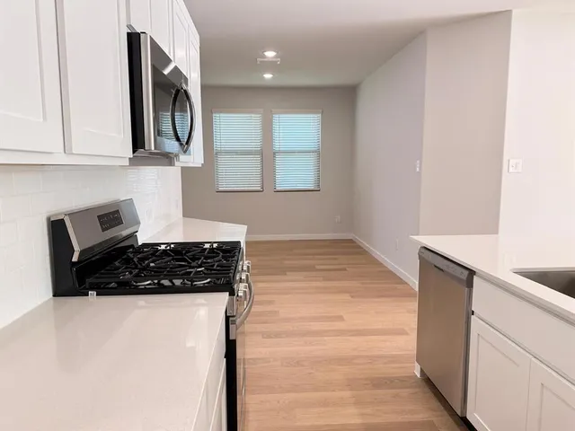a kitchen with a sink cabinets and window