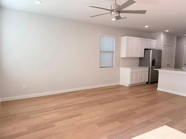 a view of kitchen with refrigerator microwave and stove