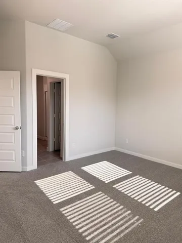 a view of a bedroom with wooden floor and closet