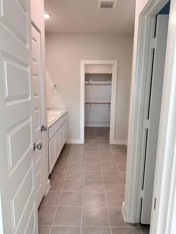 a bathroom with a tub shower and sink