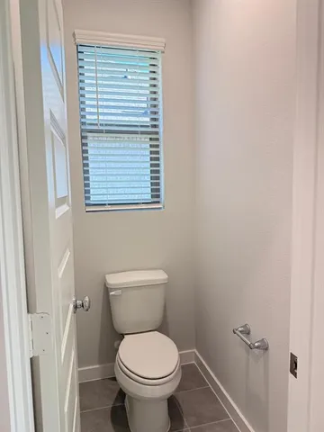a white toilet sitting next to a window