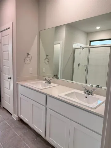 a bathroom with a sink double vanity and a mirror