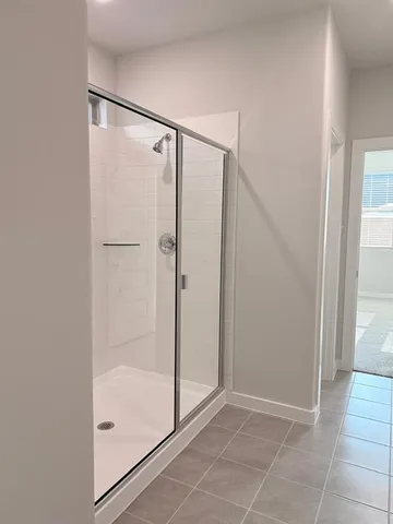 a bathroom with a glass shower door