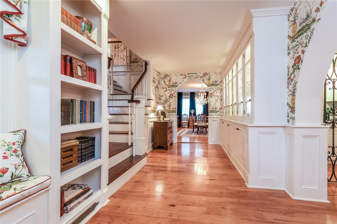 32 Broad Street Warren, RI 02885 - Photo 13 of 40 Hallway from 2nd exterior entrance on porch with custom window seats, bookcases, lit china cabinet and grand stairway.
