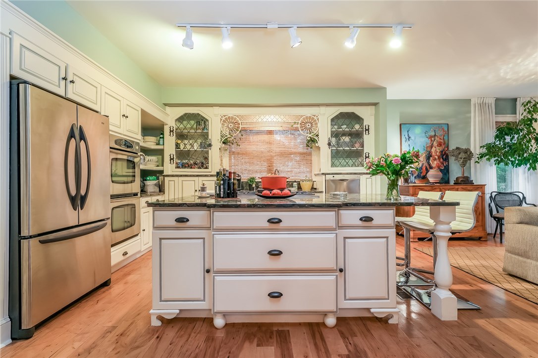 32 Broad Street Warren, RI 02885 - Photo 9 of 40 Stainless Steel Cooks Kitchen with freestanding island, granite counters and custom cabinets.