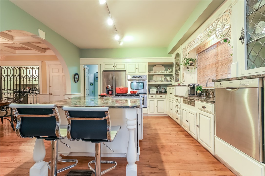 32 Broad Street Warren, RI 02885 - Photo 10 of 40 Cooks Kitchen with stainless appliances, double ovens, Decor Cooktop, antique leaded glass cupboards, pantry and iron enclosed wet bar.