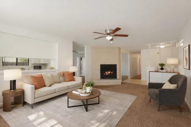 a living room with furniture and a fireplace